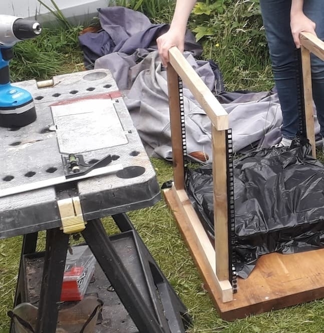 A test fit of the frame against the server. The server is also covered in a plastic bag to prevent damage from rain.