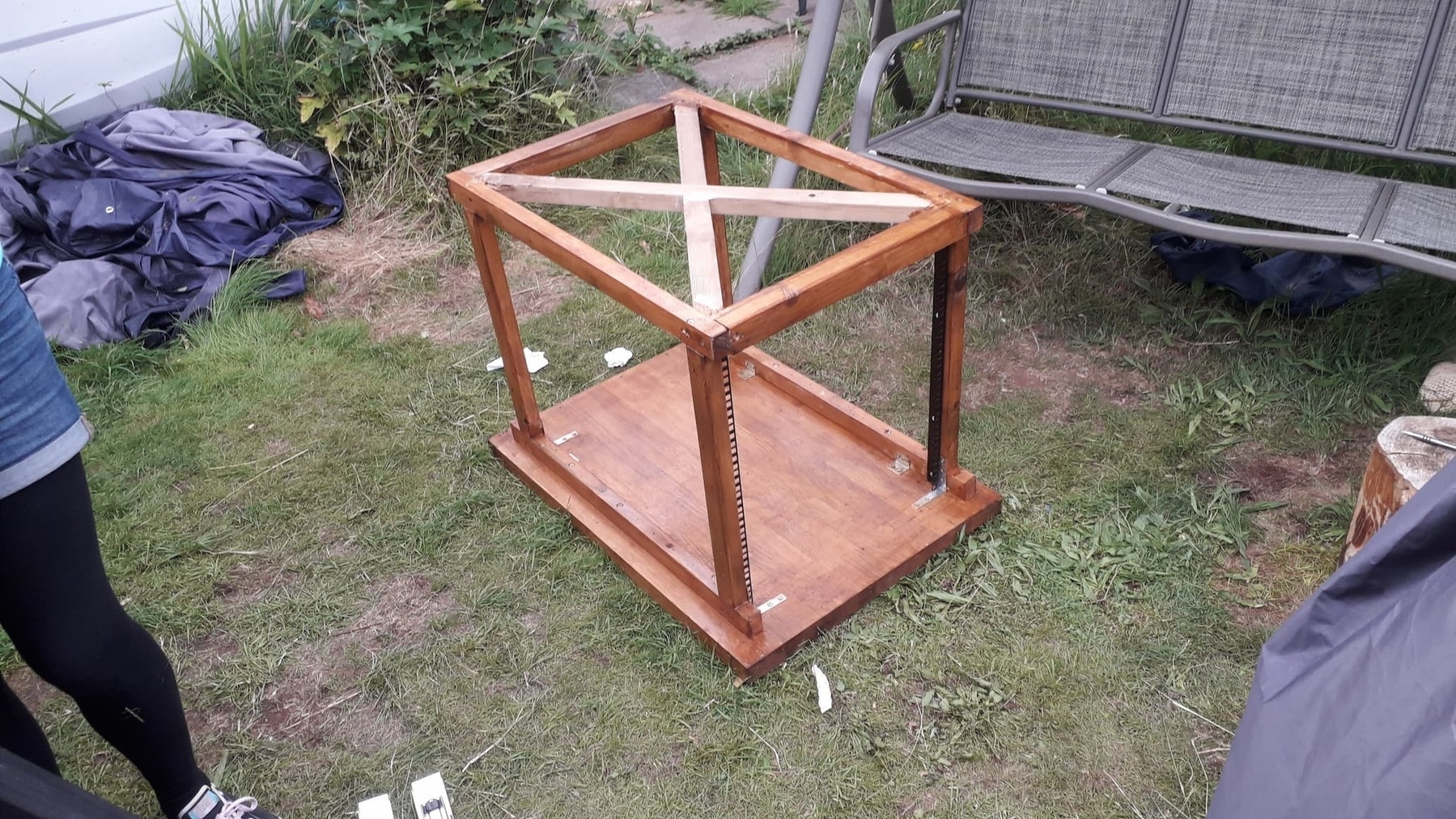 A picture showing the cabinet being treated with wood-stain